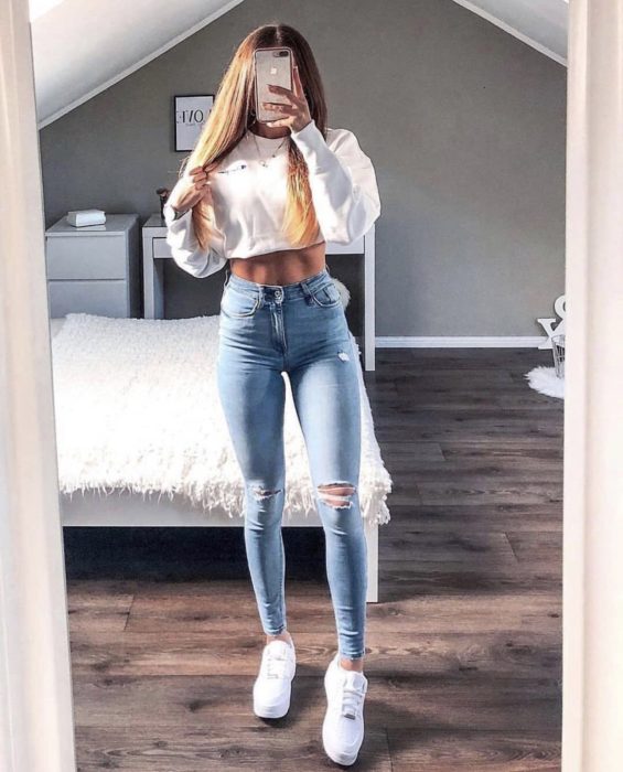 Chica usando unos skinny jeans con zapatos y blusa blanca